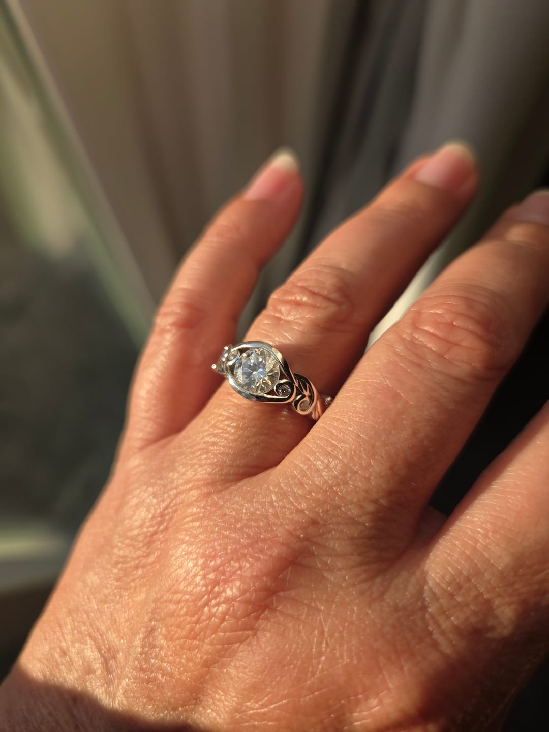 Customer photo review of Bezel Set Round Moissanite Scroll Accents Engagement Ring