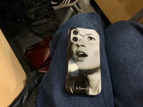Customer's gasp tough iPhone case with a black-and-white graphic print resting on a person's lap.