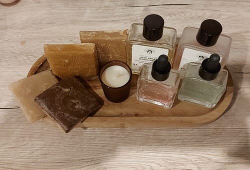 Reviewer's Skin Refining Duo - Tepezcohuite products displayed on a wooden tray with soaps and other items.