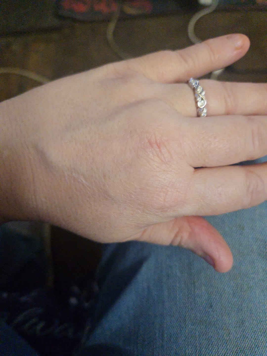 Customer photo review of Bezel Set Round Moissanite Scroll Accents Wedding Band Ring In Sterling Silver