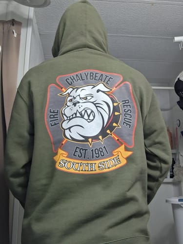 Reviewer from behind wearing the green Chalybeate Fire Rescue hoodie, showing the 'South Side' bulldog graphic on the back.