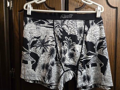 Customer's Hutstepper Boxer Briefs with a black and white tropical print hanging on a white hanger.