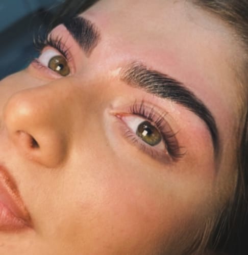 Reviewer's close-up showing lifted and curled dark lashes after using the Pink Lash Lift Powder.