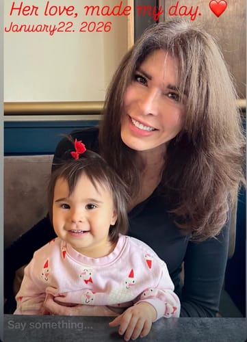 A smiling reviewer sitting with her young grandniece, enjoying family time without the interruption of a migraine.