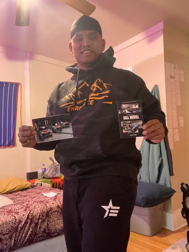 A customer standing in a room wearing the black Rogue Joggers with a white logo on the thigh.
