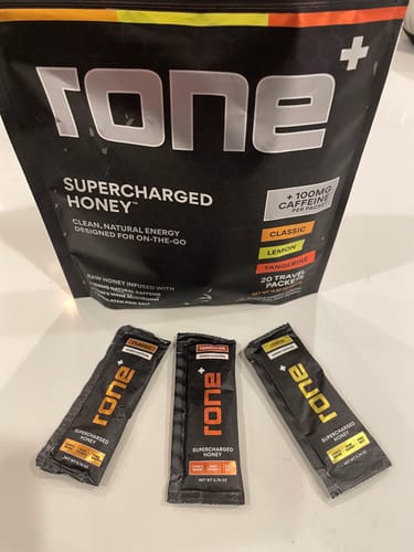 Customer's SuperCharged Honey Variety Pack, showing the main bag and three individual travel packets on a countertop.