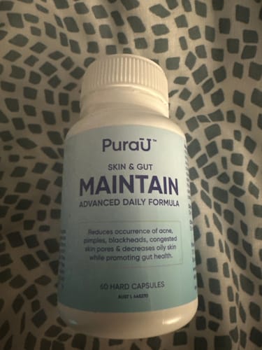 A reviewer's white bottle of Purau Skin & Gut Maintain, an advanced daily formula with 60 capsules.