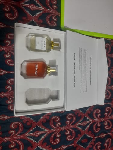 Customer's open OUD Supreme BUNDLE box, showing two fragrances with one empty slot on a patterned surface.