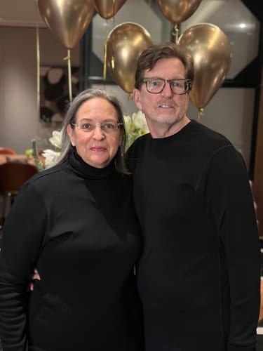 Reviewer wearing the black Peyton Turtleneck at an elegant dinner with another person.