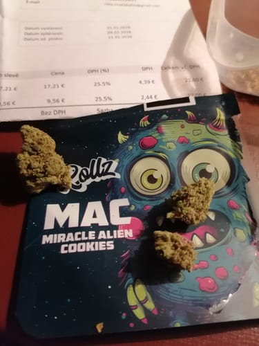Customer's Miracle Alien Cookies THCA flower buds displayed on top of the colorful product packaging.