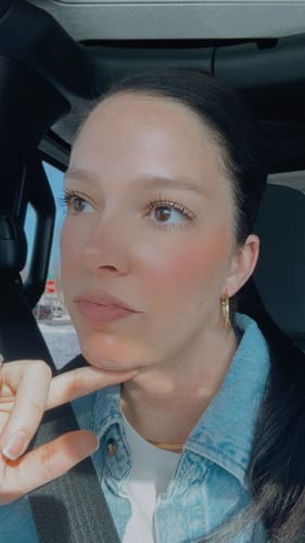 Reviewer with hair pulled back wearing the Wavy Edge Hoop Earrings.