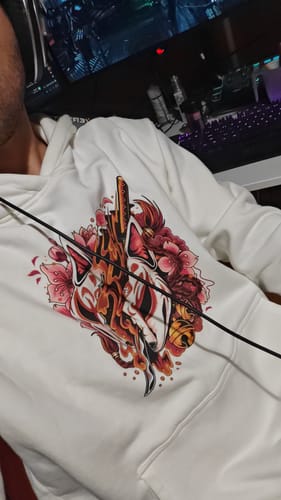 Customer wearing the white Kitsune Slayer Hoodie, showing a close-up of the detailed front print.