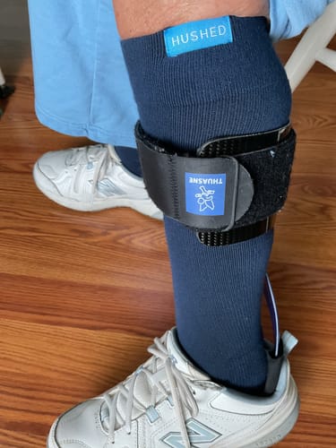 Customer wearing the navy Performance Eucalyptus Compression Socks on their leg with a sneaker and brace.