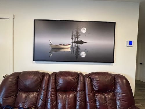 Customer's large Modern Minimalist Night Lake Wall Art hanging on a wall above a dark leather sofa.