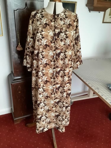 Customer's completed kaftan, made from the brown floral Faded Meadow Polyester Crepe Fabric, on a dress form.