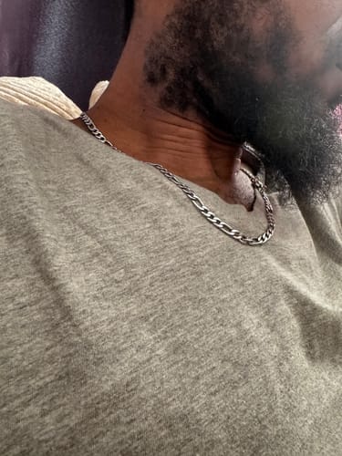 Close-up of a customer wearing the shiny 5mm Figaro Link Chain around their neck.