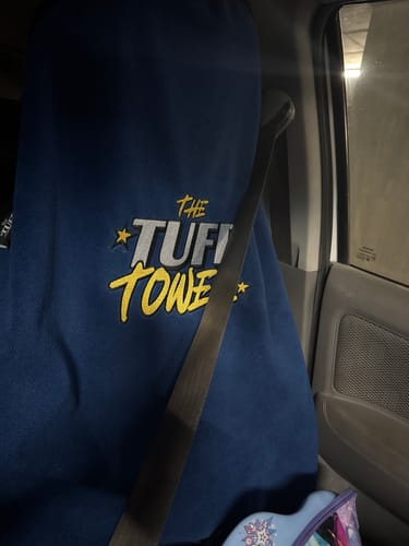 Customer's blue Waterproof Car Towel Seat Cover installed on a car's passenger seat with the logo visible.