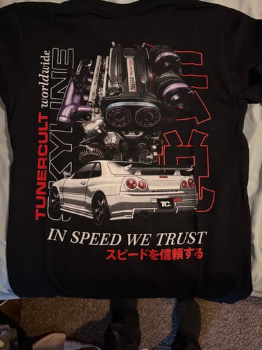 Customer's black t-shirt from the mystery box, showing a detailed Nissan Skyline GTR and engine graphic.