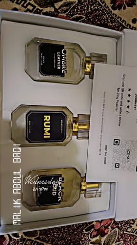 Customer's open Winter Box displaying the three glass fragrance bottles: Rumi, Ombre Leather, and Black Oud.