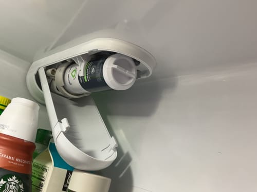 Reviewer's Glacierfresh XWFE Water Filter installed inside their refrigerator with the housing open.