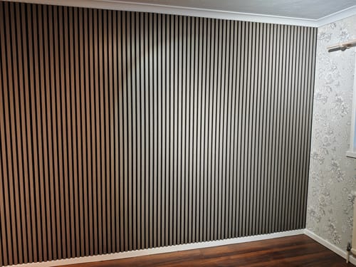 Customer's feature wall using the light brown Premium Acoustic Slatted Wall Panels in a bedroom.