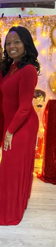 Reviewer smiling in a red, long-sleeved NW Mock Neck Maxi Dress. The dress reaches the floor.