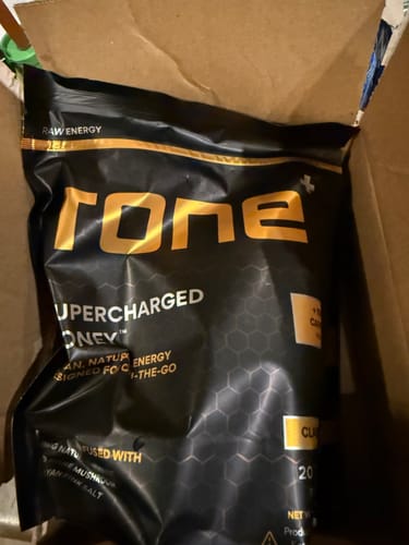 Customer's received black bag of SuperCharged Honey, showing the incorrect 100mg caffeine version in a shipping box.