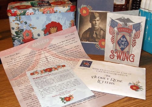 Customer's display of The Audrey Rose Letters subscription contents, including vintage-style letters and a soldier's photo.