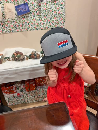 Reviewer's child playfully wearing the gray and black Imperial Officer Hat, pulled low over their eyes.