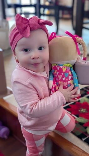 Customer's photo shows a young child in a pink outfit happily holding the Princess Starlet doll.