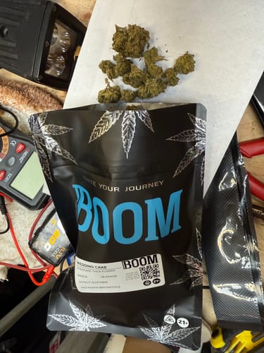 Customer displays the Wedding Cake flower poured out from its black packaging onto a white surface.