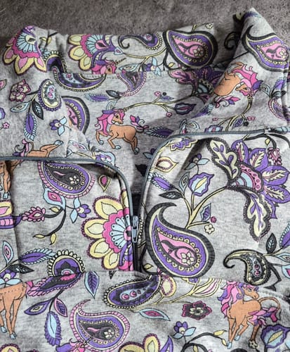 Customer's close-up of a half-zip sweatshirt made from the colorful Unicorns and Paisley Sweatshirt Fabric.