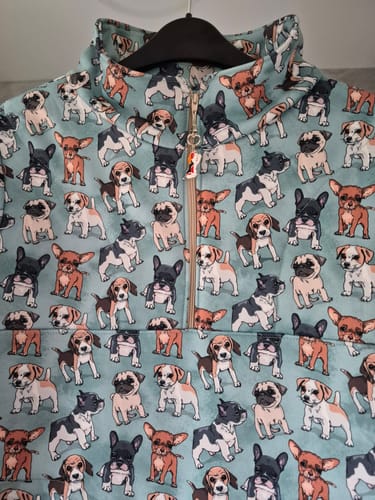 Close-up of a customer's quarter-zip sweatshirt made from the cute Playful Dogs Sweatshirt Fabric.