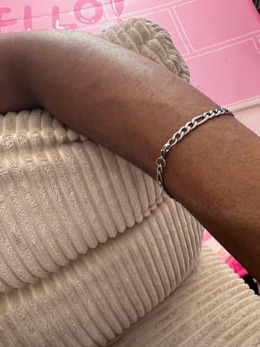 Customer's wrist showing the perfect fit of the silver-colored 5mm Figaro Link Bracelet.