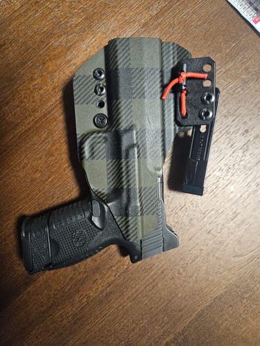 Customer's green plaid XIPHOS ELITE holster with a handgun inside, showing the back of the holster.