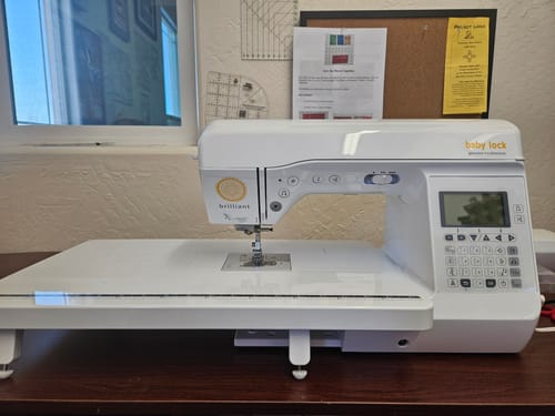 Reviewer's white Extension Table attached to a Babylock Brilliant sewing machine, creating a large workspace.