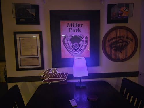 Customer's Indiana Hoosiers metal wall art on a table in their decorated basement bar.