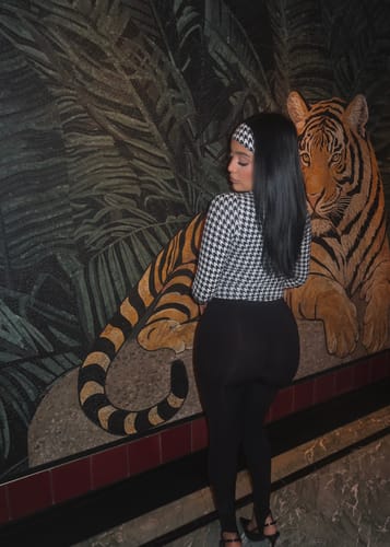 Customer from behind wearing the sleek black Naked Stirrup Legging, showing the bodycon fit.