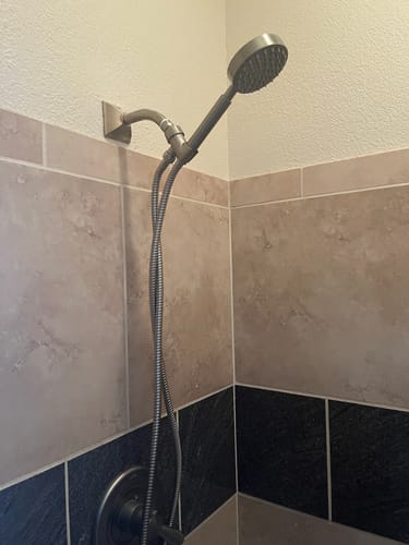 Customer's new 1-Spray Handheld Shower Head Set installed in a tiled shower.