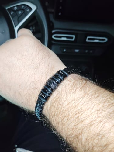 Customer wearing the personalized black bracelet on their wrist while in a car.