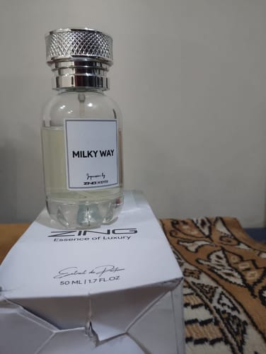 Customer's Milky Way perfume in a clear glass bottle, resting on its white packaging box.