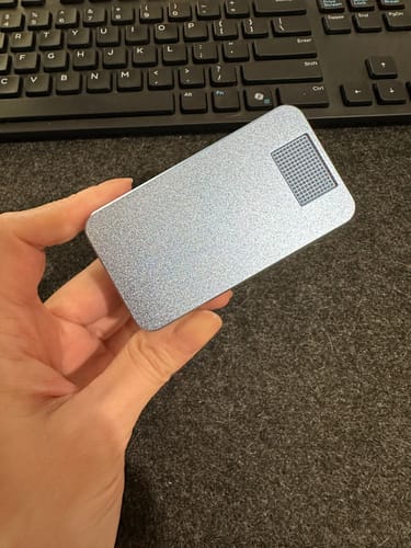 Customer holding their sparkly, light blue Mission Case flat in their hand.