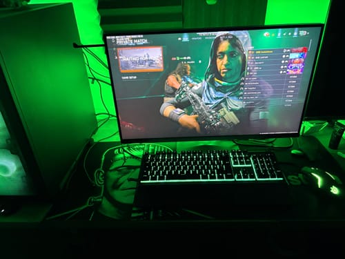 Customer's custom iD Colossus mousepad with a Frankenstein design on a gaming setup with green lighting.