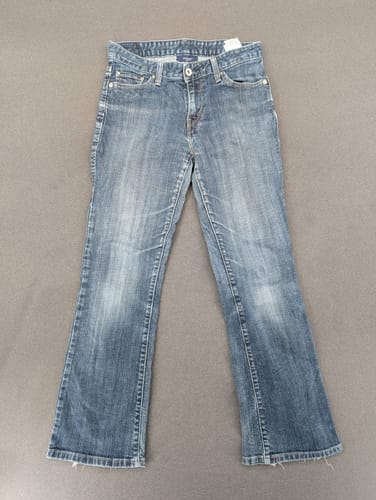 Reviewer's pair of blue bootcut Womens Levis Jeans laid flat on a grey surface.