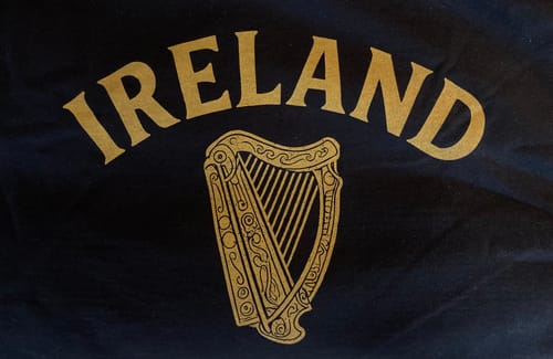 Close-up: Customer's Ireland Vintage Harp T-Shirt showing the gold harp and 'IRELAND' text on the dark fabric.