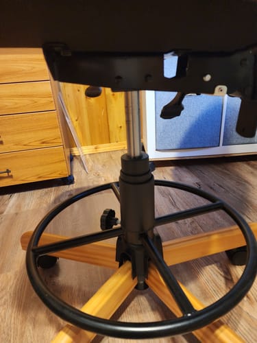 Customer's close-up of the newly installed SewComfort Chair Piston on the chair's wooden base.