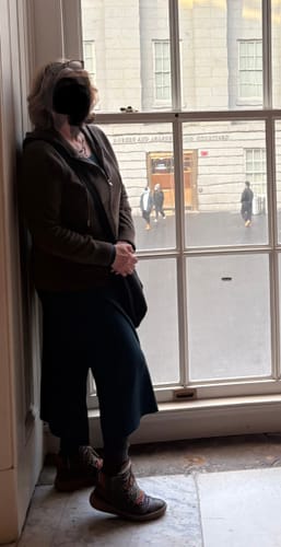 Reviewer showing the fit of the Caroline Ribbed Twirl Dress, styled with a hoodie and leggings indoors.