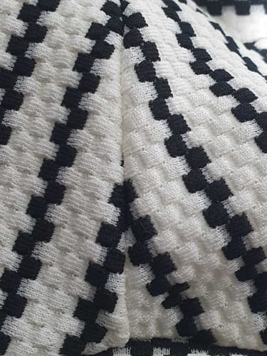 Customer's close-up photo showing the textured black and white pattern of the Pixel Stripe Knit Jersey Fabric.