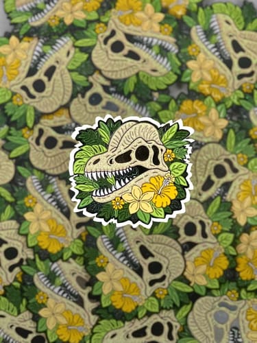 Customer's custom sticker design of a crested dinosaur skull surrounded by bright yellow tropical flowers.