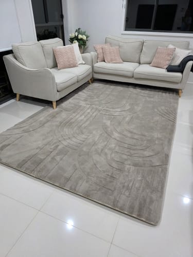 Customer's Mellow Mat with the Underlay beneath, showing the mat's raised edges in a living room setting.